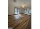Spacious bedroom with wood-look flooring, ceiling fan, and multiple windows at 5003 Pineview Ter, Fayetteville, GA 30214