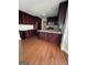 Eat-in kitchen with granite countertops, dark wood cabinets, and hardwood floors at 5003 Pineview Ter, Fayetteville, GA 30214