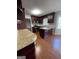 Eat-in kitchen with granite countertops, dark wood cabinets, and hardwood floors at 5003 Pineview Ter, Fayetteville, GA 30214