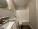 Bathroom with granite countertop and a tub/shower combo at 5950 Community Se Rd, Mableton, GA 30126