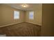 Spacious bedroom with neutral carpeting and two windows at 5950 Community Se Rd, Mableton, GA 30126