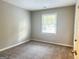 Bright bedroom with neutral walls and carpet at 2190 Westover Dr, East Point, GA 30344