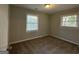 Well-lit bedroom with neutral walls, plush carpeting, and two windows at 2190 Westover Dr, East Point, GA 30344