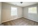 Bright bedroom featuring neutral walls, plush carpeting, and two windows at 2190 Westover Dr, East Point, GA 30344