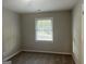 Simple bedroom with neutral walls, window blinds, and plush carpeting at 2190 Westover Dr, East Point, GA 30344