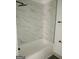 Bathroom with marble shower surround and tile floor at 1511 Mims Sw St, Atlanta, GA 30314