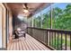 Relaxing screened porch with comfy seating and ceiling fan at 5 Northlake Cir, Peachtree City, GA 30269