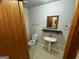 Clean bathroom with pedestal sink and toilet at 1004 Alford Ct, Lithonia, GA 30058