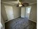 Bedroom with carpet, ceiling fan, and access to hallway at 1004 Alford Ct, Lithonia, GA 30058