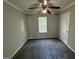 Well-lit bedroom with ceiling fan, crown molding, and neutral carpet at 1004 Alford Ct, Lithonia, GA 30058