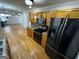Kitchen with hardwood floors, wooden cabinets and black appliances at 1004 Alford Ct, Lithonia, GA 30058