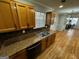 Kitchen with hardwood floors, wooden cabinets and black appliances at 1004 Alford Ct, Lithonia, GA 30058