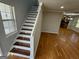 Modern staircase with a clean design and hardwood steps at 1004 Alford Ct, Lithonia, GA 30058