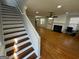 Elegant staircase with wood and white risers leading to the upper level at 1004 Alford Ct, Lithonia, GA 30058