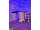 Modern wet bar with wine storage and blue lighting at 6880 Cumberland Cir, Riverdale, GA 30296