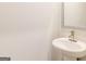 Small bathroom with pedestal sink, and a framed mirror at 145 Weldon St # 59, Mcdonough, GA 30253