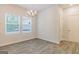 Bright dining room with chandelier and wood-look floors at 145 Weldon St # 59, Mcdonough, GA 30253
