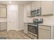 Modern kitchen features stainless steel appliances and granite countertops at 145 Weldon St # 59, Mcdonough, GA 30253