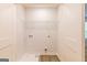 Bright laundry room with built-in shelving and vinyl flooring at 145 Weldon St # 59, Mcdonough, GA 30253