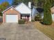 Brick ranch home with attached garage and landscaped yard at 2644 Laurel Nw Ln, Kennesaw, GA 30152