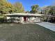 Newly painted ranch home with red front door and carport at 2138 Springdale Rd, Atlanta, GA 30315
