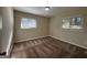 Spacious carpeted bedroom with two windows and neutral walls at 2233 Springdale Sw Cir, Atlanta, GA 30315