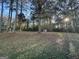 Large backyard with mature trees and a shed at 245 Remington Trl, Ellenwood, GA 30294