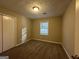 Simple bedroom with carpet, window, and closet at 245 Remington Trl, Ellenwood, GA 30294
