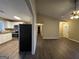 Open concept kitchen and living area with white cabinets at 245 Remington Trl, Ellenwood, GA 30294