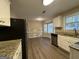Kitchen with granite counters, stainless steel appliances, and wood flooring at 245 Remington Trl, Ellenwood, GA 30294