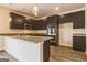 Modern kitchen with dark cabinetry, granite countertops, and stainless steel appliances at 207 Fern Dale Drive Dr # 122, Fairburn, GA 30213