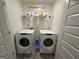 Laundry room with two Whirlpool washers and dryers at 142 Hampton Cir, Mcdonough, GA 30253