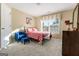 Charming bedroom with red and white bedding and a blue chair at 2202 Escalade Ct, Conyers, GA 30094