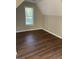 Bright bedroom with large window and wood-look floors at 11684 Heritage Dr, Hampton, GA 30228