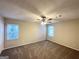 Spacious bedroom with ceiling fan and two windows at 6235 Creekford Ln, Lithonia, GA 30058