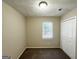 Well-lit bedroom featuring a window with blinds and double-door closet at 6235 Creekford Ln, Lithonia, GA 30058