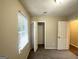 Bedroom with window, closet, and door to hallway at 6235 Creekford Ln, Lithonia, GA 30058