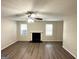 Living room with fireplace, hardwood floors, and multiple windows at 6235 Creekford Ln, Lithonia, GA 30058