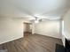 Spacious living room featuring hardwood floors and a ceiling fan at 6235 Creekford Ln, Lithonia, GA 30058