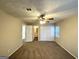 Main bedroom with ceiling fan, en-suite bathroom access, and double closet at 6235 Creekford Ln, Lithonia, GA 30058
