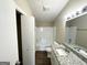 Bathroom with granite countertop, tub shower, and closet at 7125 Rhodes St, Lithonia, GA 30058