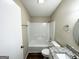 Clean bathroom with tub shower, granite vanity, and updated fixtures at 7125 Rhodes St, Lithonia, GA 30058