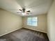 Bright bedroom featuring ceiling fan and neutral carpeting at 7125 Rhodes St, Lithonia, GA 30058