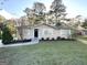 Charming ranch home with a well-maintained lawn and inviting front entrance at 7125 Rhodes St, Lithonia, GA 30058
