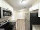 Updated kitchen with stainless steel appliances and granite countertops at 7125 Rhodes St, Lithonia, GA 30058