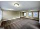 Bright living room with neutral walls and carpet at 7125 Rhodes St, Lithonia, GA 30058