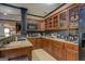 Well-equipped basement kitchenette with wood cabinets and granite countertops at 16 Hawkstone Ct, Acworth, GA 30101