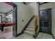 Basement stairs with wood railing leading to a game room and other amenities at 16 Hawkstone Ct, Acworth, GA 30101