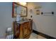 Dark wood bathroom vanity with granite countertop and decorative mirror at 16 Hawkstone Ct, Acworth, GA 30101