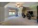 Bonus room with a TV, gaming chairs, and ceiling fan at 16 Hawkstone Ct, Acworth, GA 30101